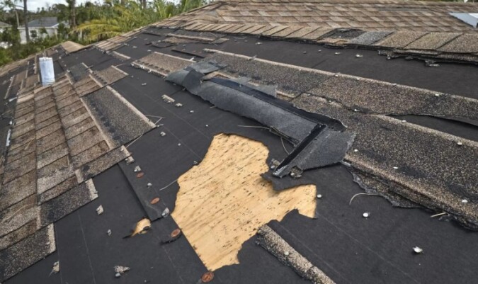 A significant section of the roof's covering is missing