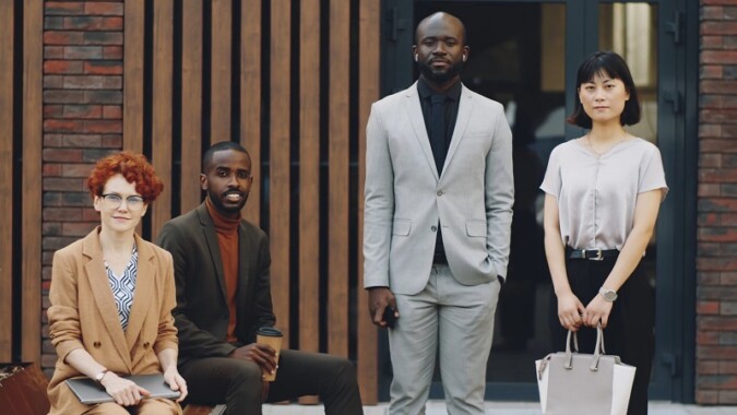 A professional group portrait showcasing workplace diversity and a multilingual team