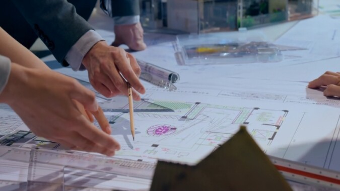 Engineers review detailed project plans together to guide key decisions